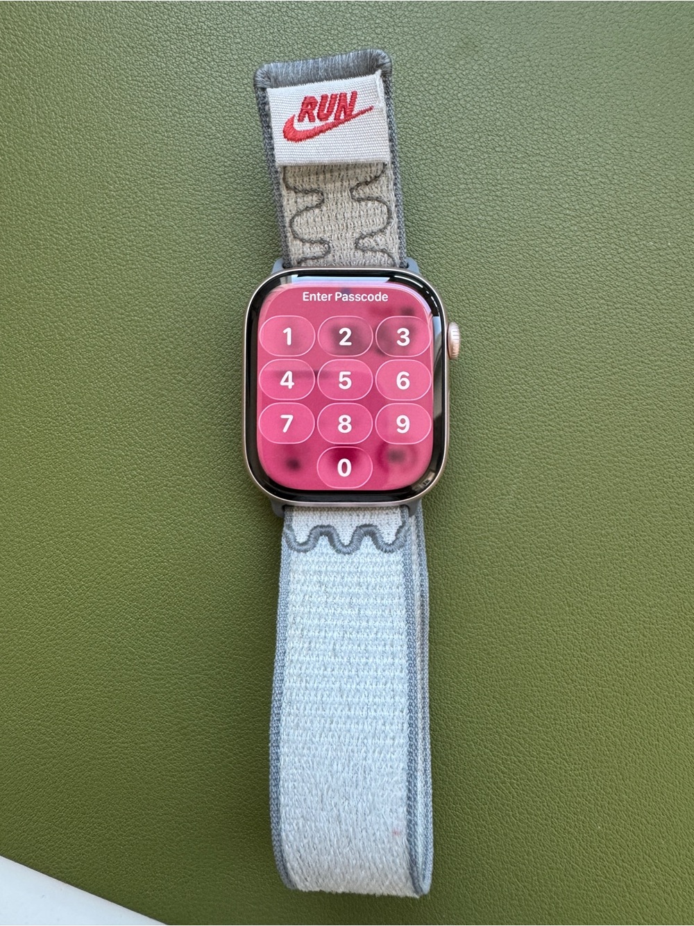 Apple Watch with Pink Passcode Screen and Light Gray Fabric Band 46mm